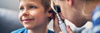Doctor examining child patient's ear